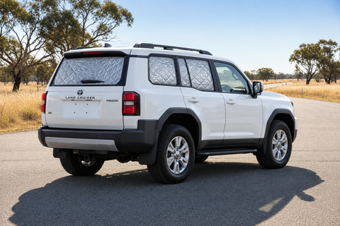 White Toyota Prado 250 Series GX/GXL with silver quilted insulated block-out screens on rear passenger, cargo and tailgate windows, with front windows clear.