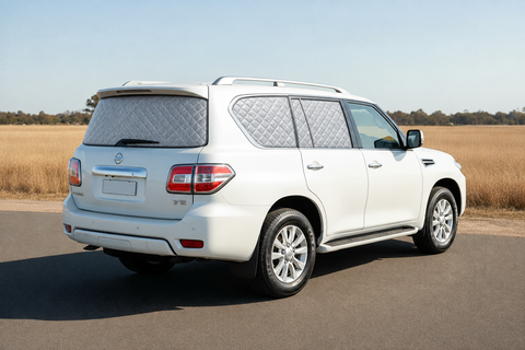 Nissan Y62 Patrol TI-L Touring Set with silver quilted insulated block-out screens on rear passenger, cargo and tailgate windows, with front windows clear.