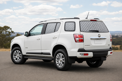 White Holden Colorado 7 with silver quilted insulated block-out rear Touring screens and clear front glass.